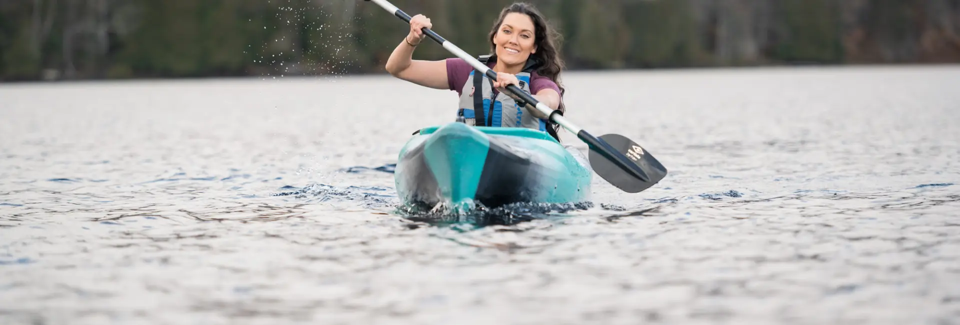 A woman paddles in fall. 