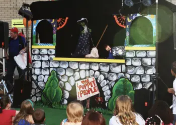 The main stage for The Puppet People featuring an illustration of a stone castle