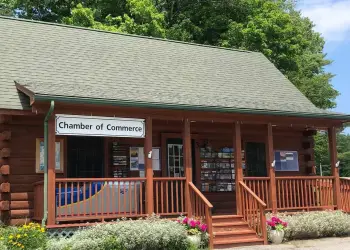 Exterior of the log cabin with covered porch of the North Warren Chamber