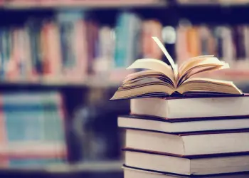 stack of books with an open book on top