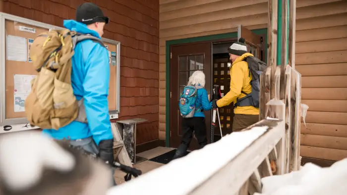 A few people walking into the AIC in the winter