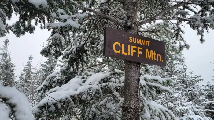 A wooden sign for Cliff Mtn