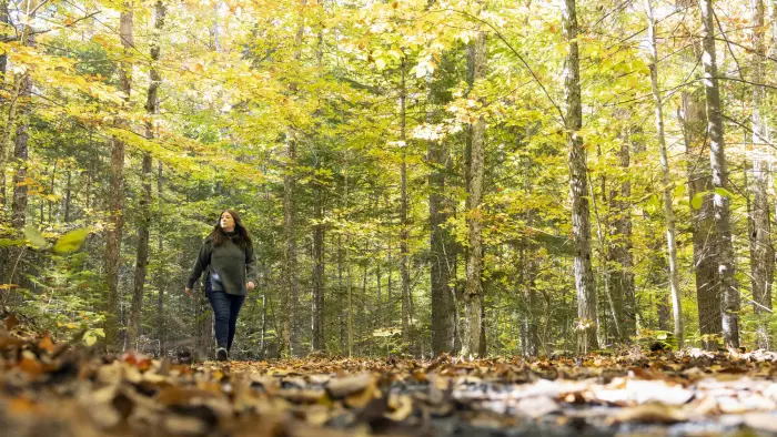 A woman walks on the trail at the AIC.