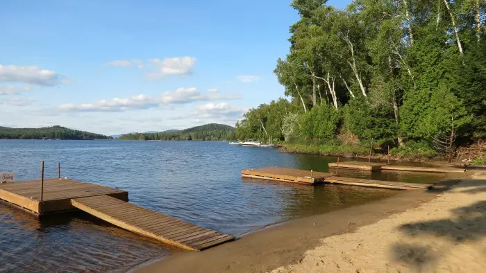 A sandy beach with docks.