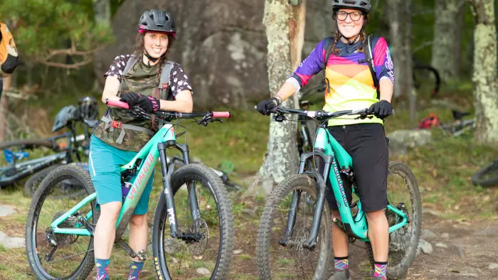 Smiling faces on matching teal bikes