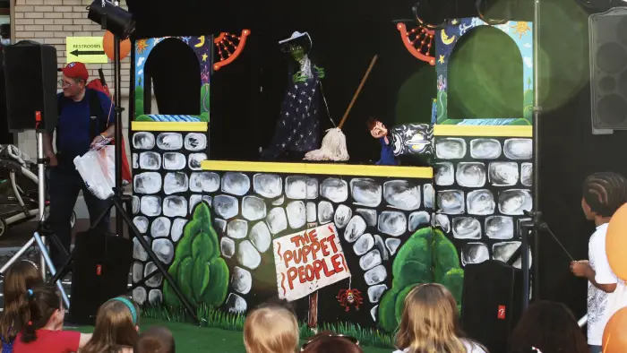 The main stage for The Puppet People featuring an illustration of a stone castle