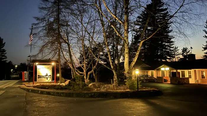 warm lights on the Paddlers Rest sign at dusk