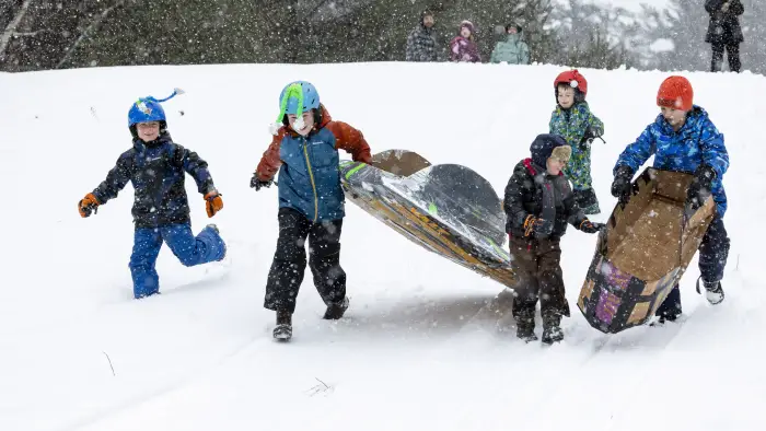 Kids running winter snow sled