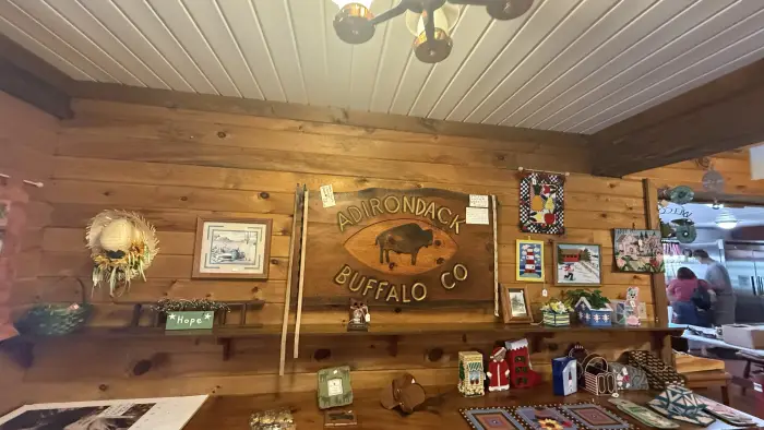 Entry sign for the Adirondack Buffalo Company with various merchandise for sale surrounding it