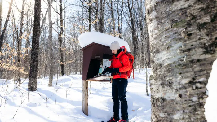 Snowshoer signing into trail register