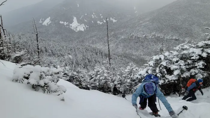 Hikers going up a steep&#44; snowy slope