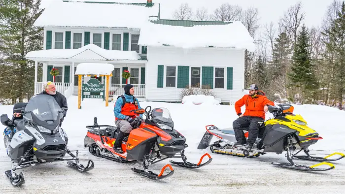 Snowmobilers parked at the Inn at Santanoni