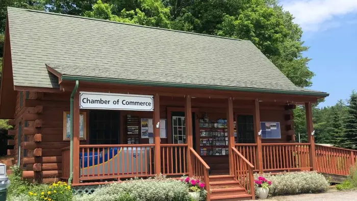 Exterior of the log cabin with covered porch of the North Warren Chamber