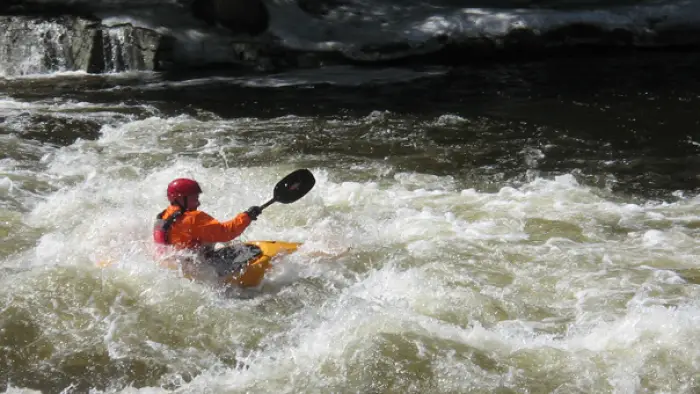 A whitewater kayaker in a rapid