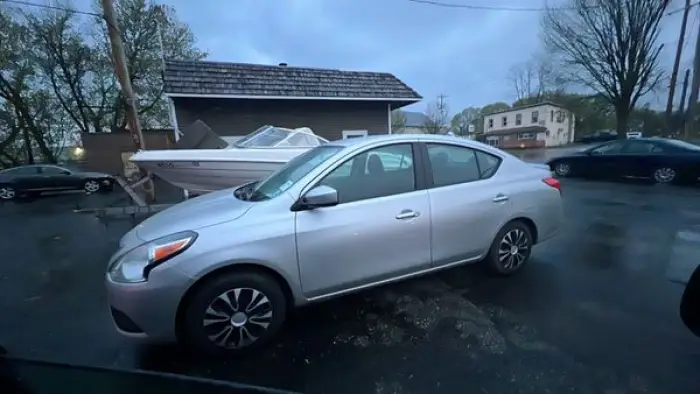 A silver 2019 Nissan Versa available for taxi rides