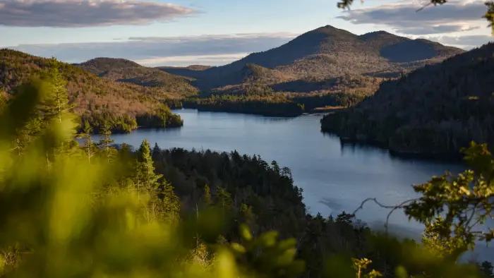 A view of a narrow lake nestled amongst mountain