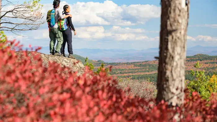 A couple at a rocky outcropping on Treadway Mountain