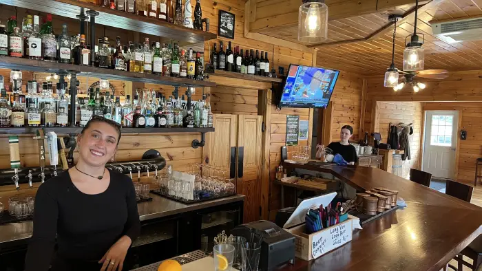 picture of long view lodge in winter with many snow mobiles parked outside