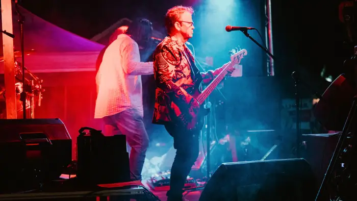 Singer playing guitar on stage