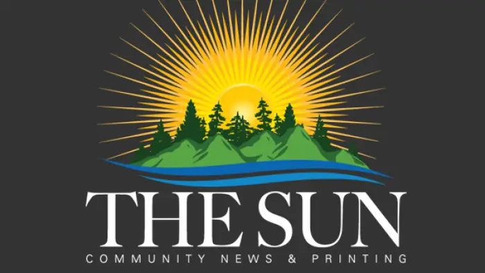 The Sun Logo of a large yellow sun