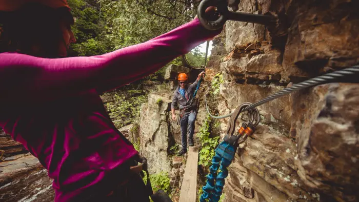 Experience the chasm from above harnessed to cables and walking wooden planks