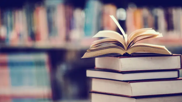 stack of books with an open book on top