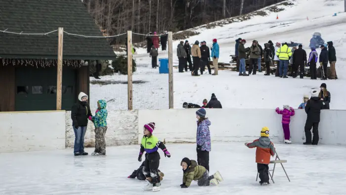 Ice skating by a sledding hill