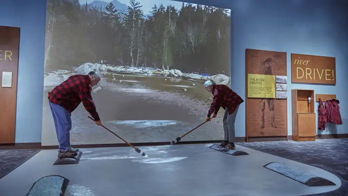 A fabric tent covering a raised deck next to the pond