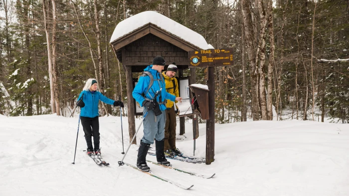Cross-country skiers at a trailhead. 