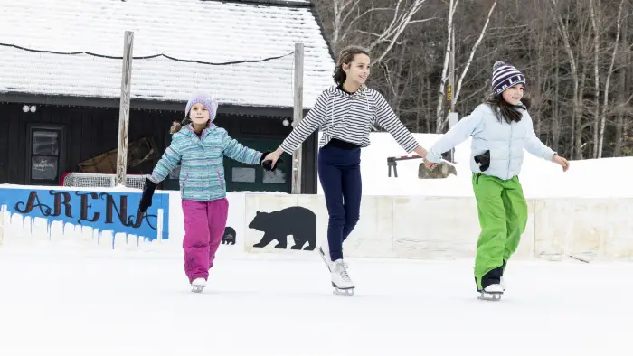three girls ice skating