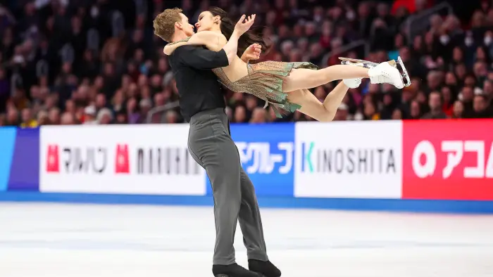  a woman in a red dress and a man in a blue suit