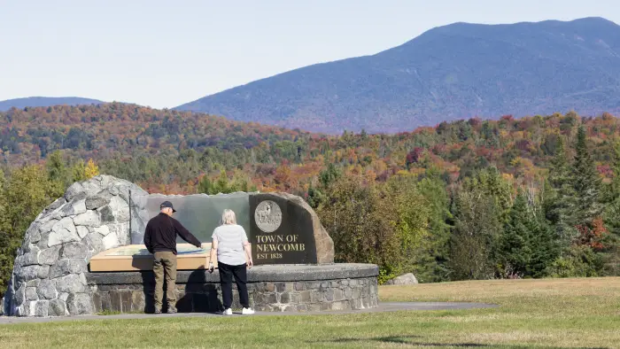 A couple people check out an overlook in the fall