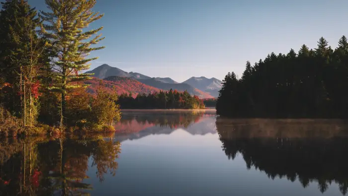 A mountain view reflecting in the water during the fall