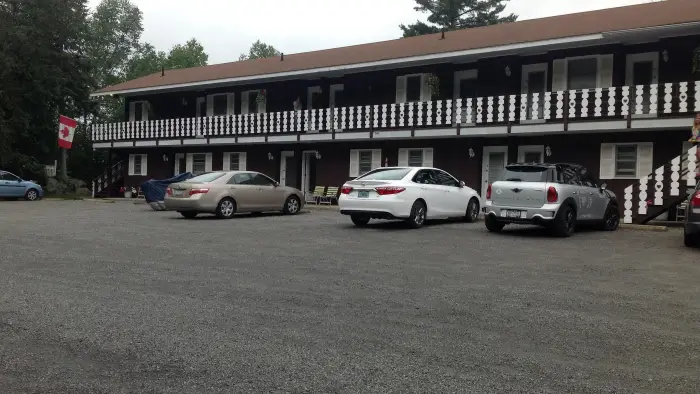 The parking area looking at the rooms and balcony at Sandy Point Motel.