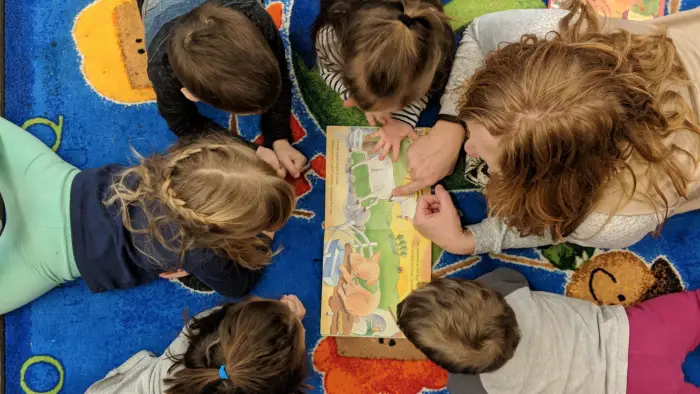 Kids laying around reading a book