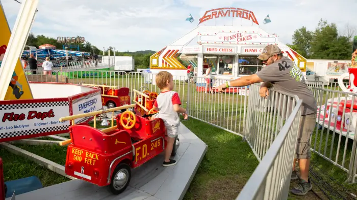 Man reaches out to child on amusement park ride