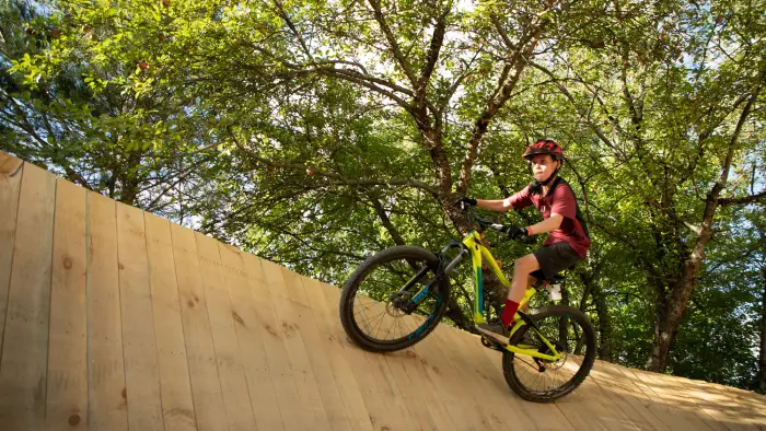 riding up a big wall in the woods