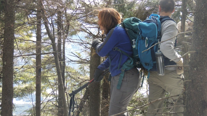 Two hikers with large packs taking a break