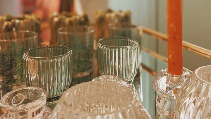 A variety of colorful wrist warmers hang on a line.