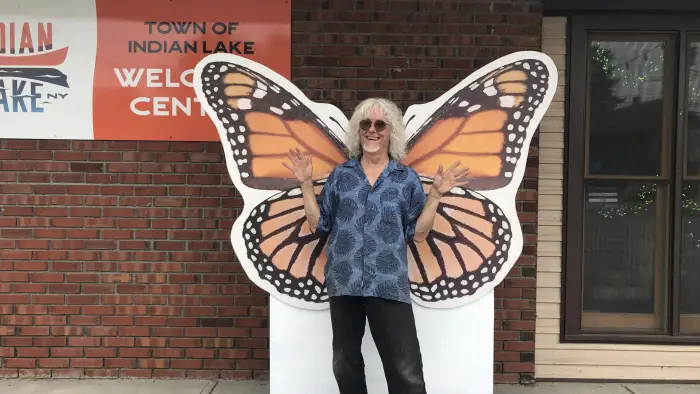 a man posing in front of the monarch photo prop