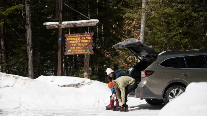 Two crosscountry skiers getting ready in the Big Pond parking lot