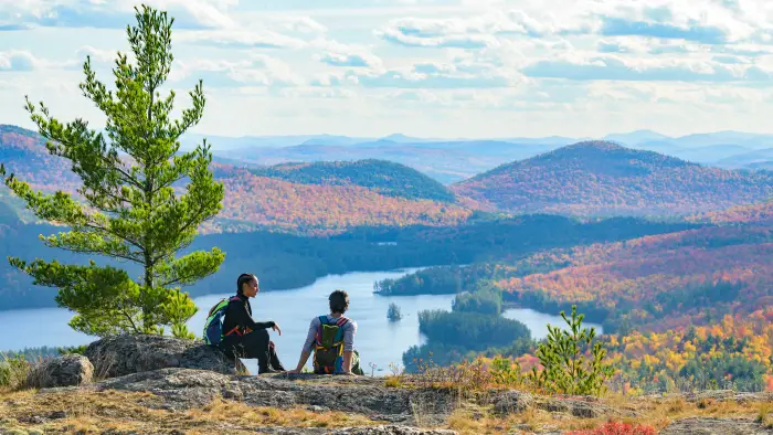 A couple on the Treadway Mountain summit during fall.