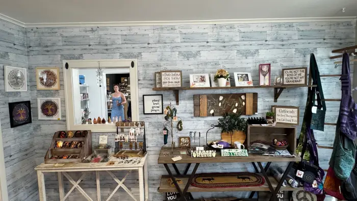 Various sizes of Buck Mountain Maple Syrup arranged on a shelf.