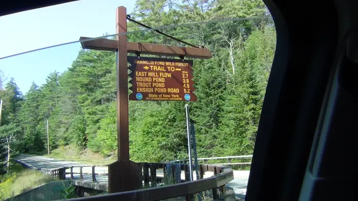 A yellow and brown campground sign
