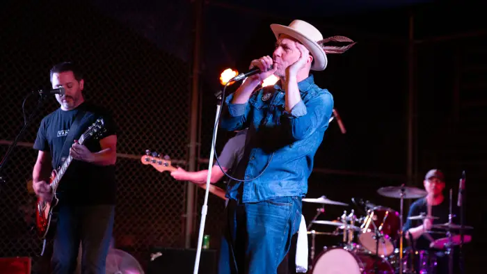 Band playing on stage with guitarist&#44; singer and drums