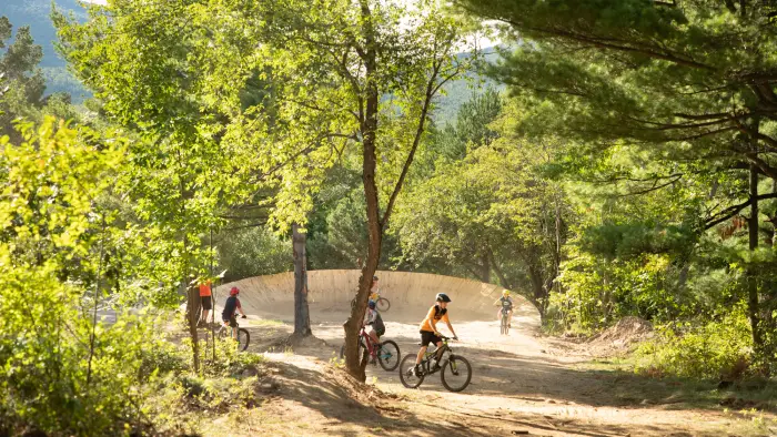 Big burm wall in the woods with young kids practicing