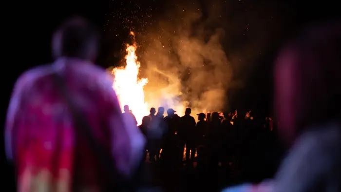 Backed up view of the crowd in front of the bonfire