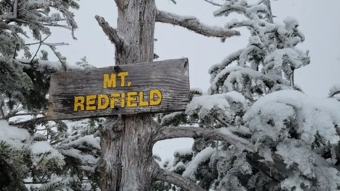 A wood sign for Mt Redfield