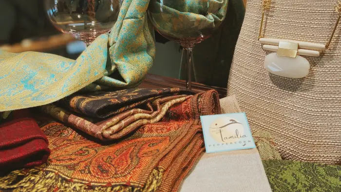 An ice queen in the front display window next to the illuminated OPEN sign.