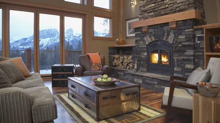 A grand living room with stone hearth and mountain views